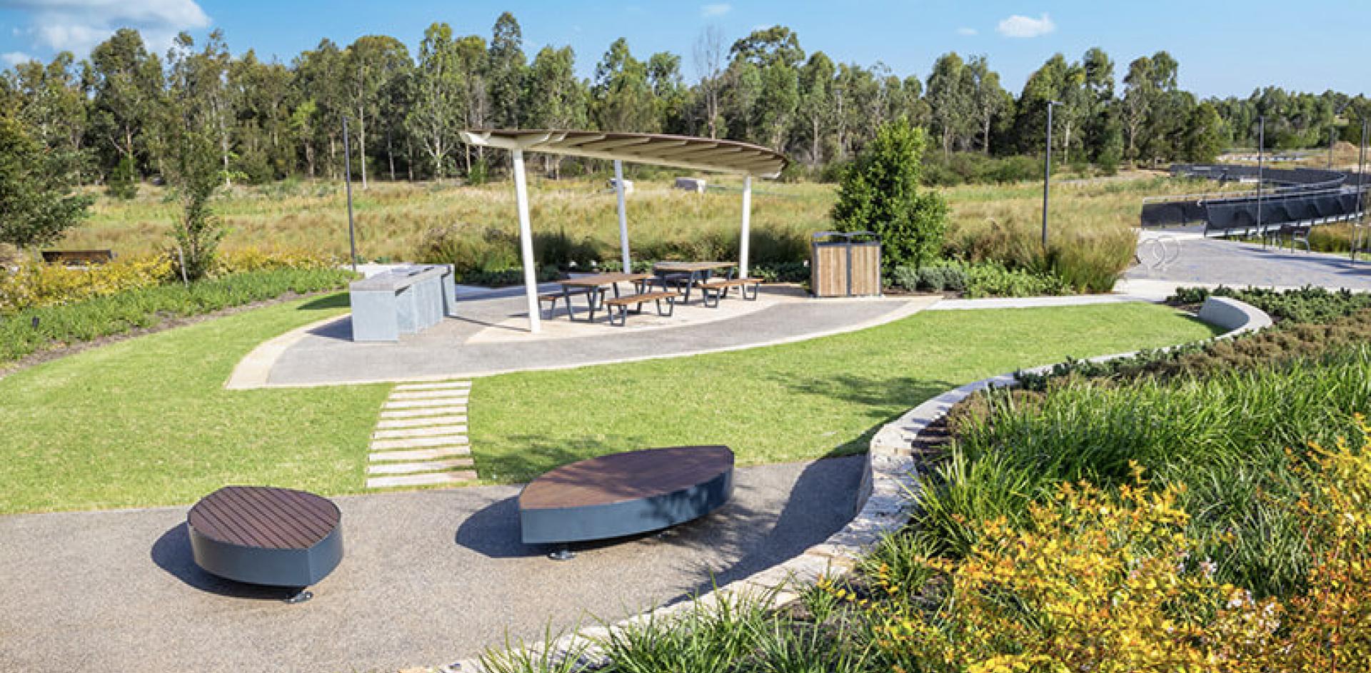 Public barbecue and seating area in green park